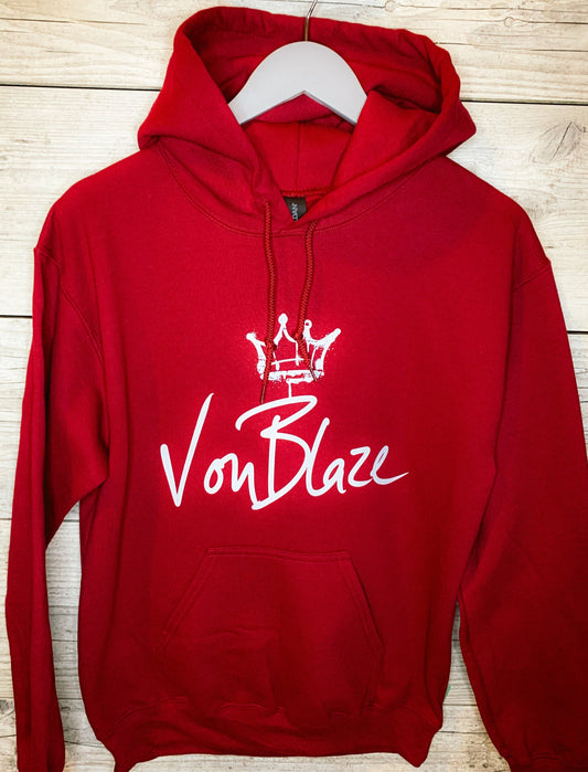 Red hoodie with 'Von Blaze' logo on a wooden surface